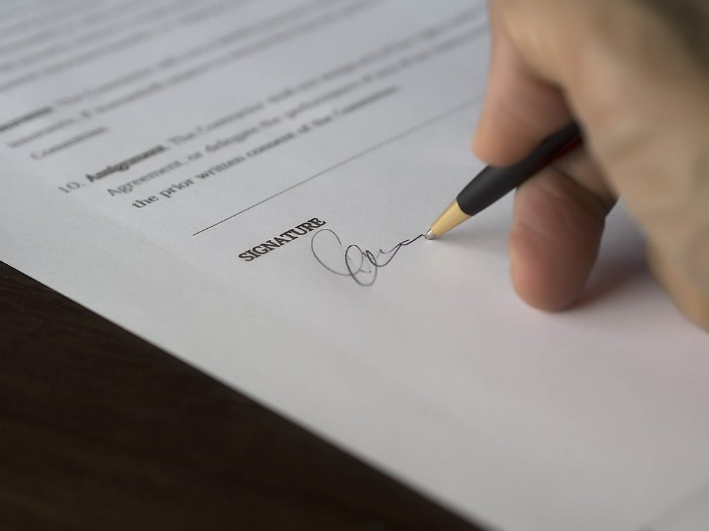 Picture of person signing document